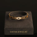 Tavisi black evil eye gold bracelet with CZ stones in 22K gold plated 316L surgical stainless steel with open lock design size 2.4
