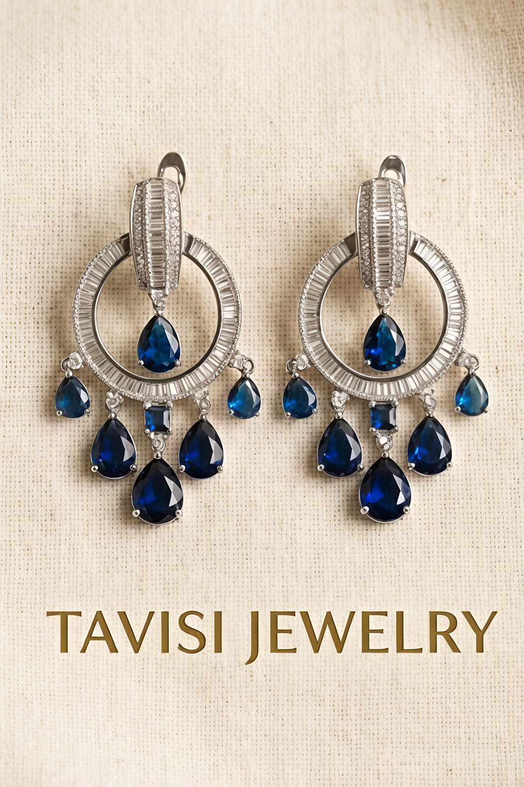 Tavisi blue sapphire CZ chandelier earrings displayed in silver tone with premium CZ stones
