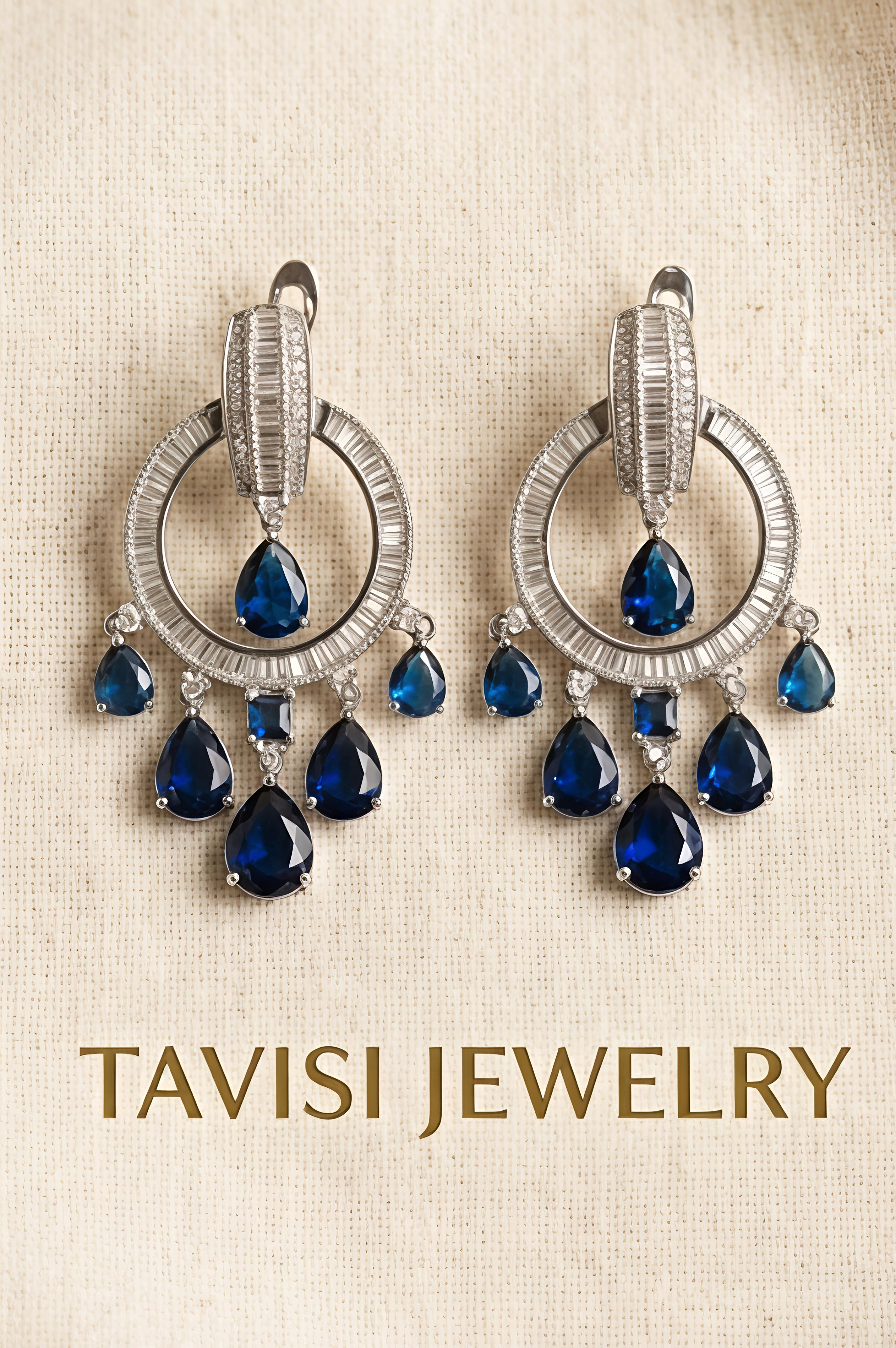 Tavisi blue sapphire CZ chandelier earrings displayed in silver tone with premium CZ stones
