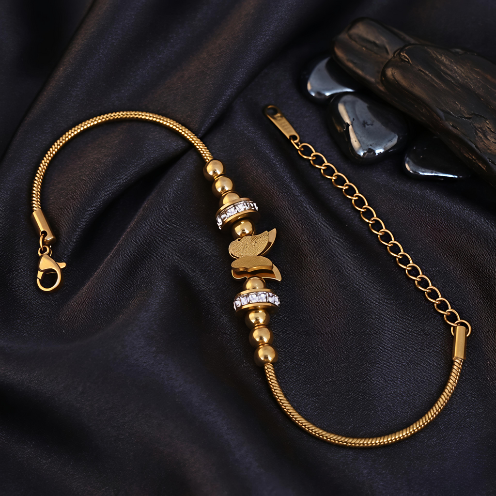 Close-up view of Tavisi Butterfly Charm Bracelet featuring zircon stone details, anti tarnish finish and long lasting 22K gold plated shine.
