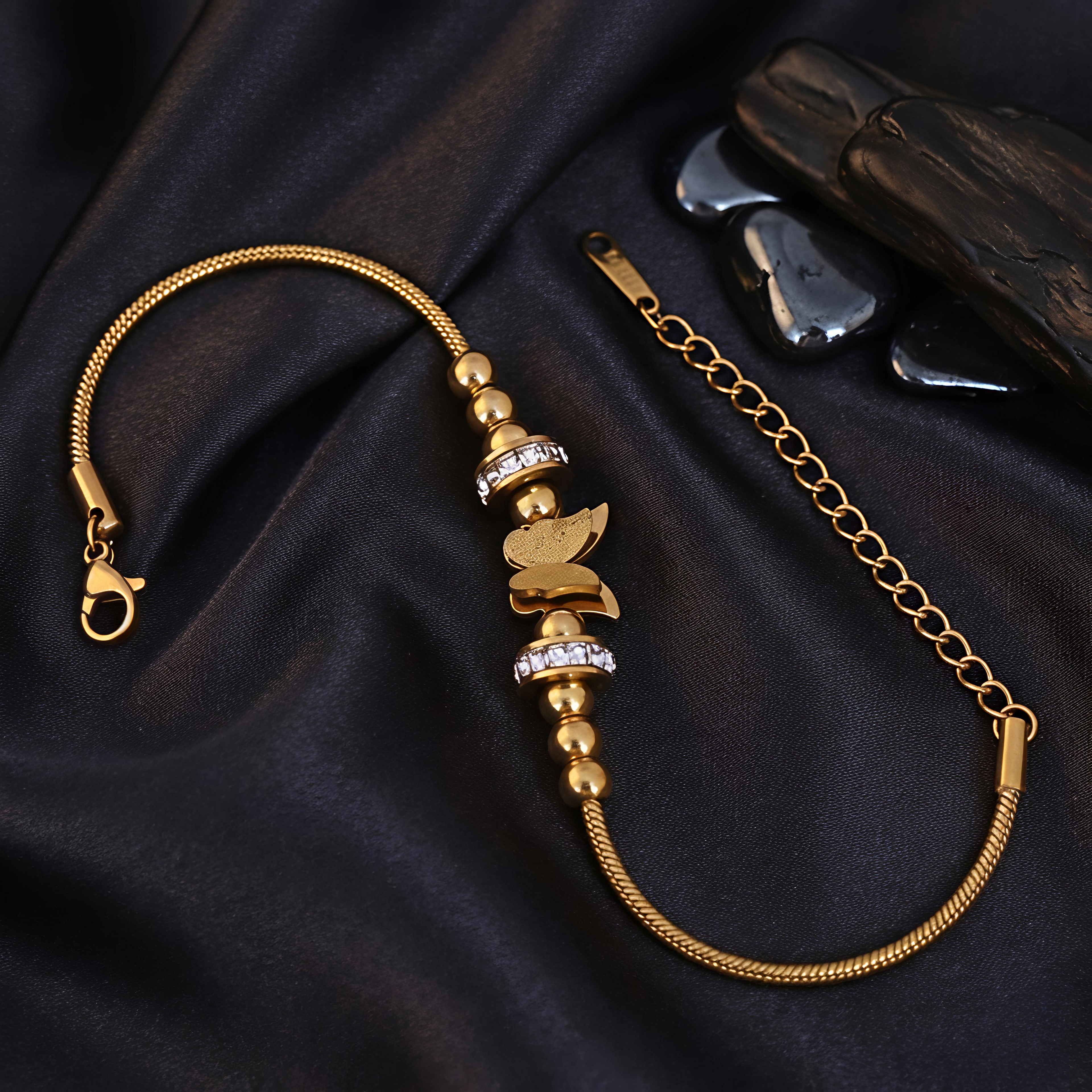Close-up view of Tavisi Butterfly Charm Bracelet featuring zircon stone details, anti tarnish finish and long lasting 22K gold plated shine.