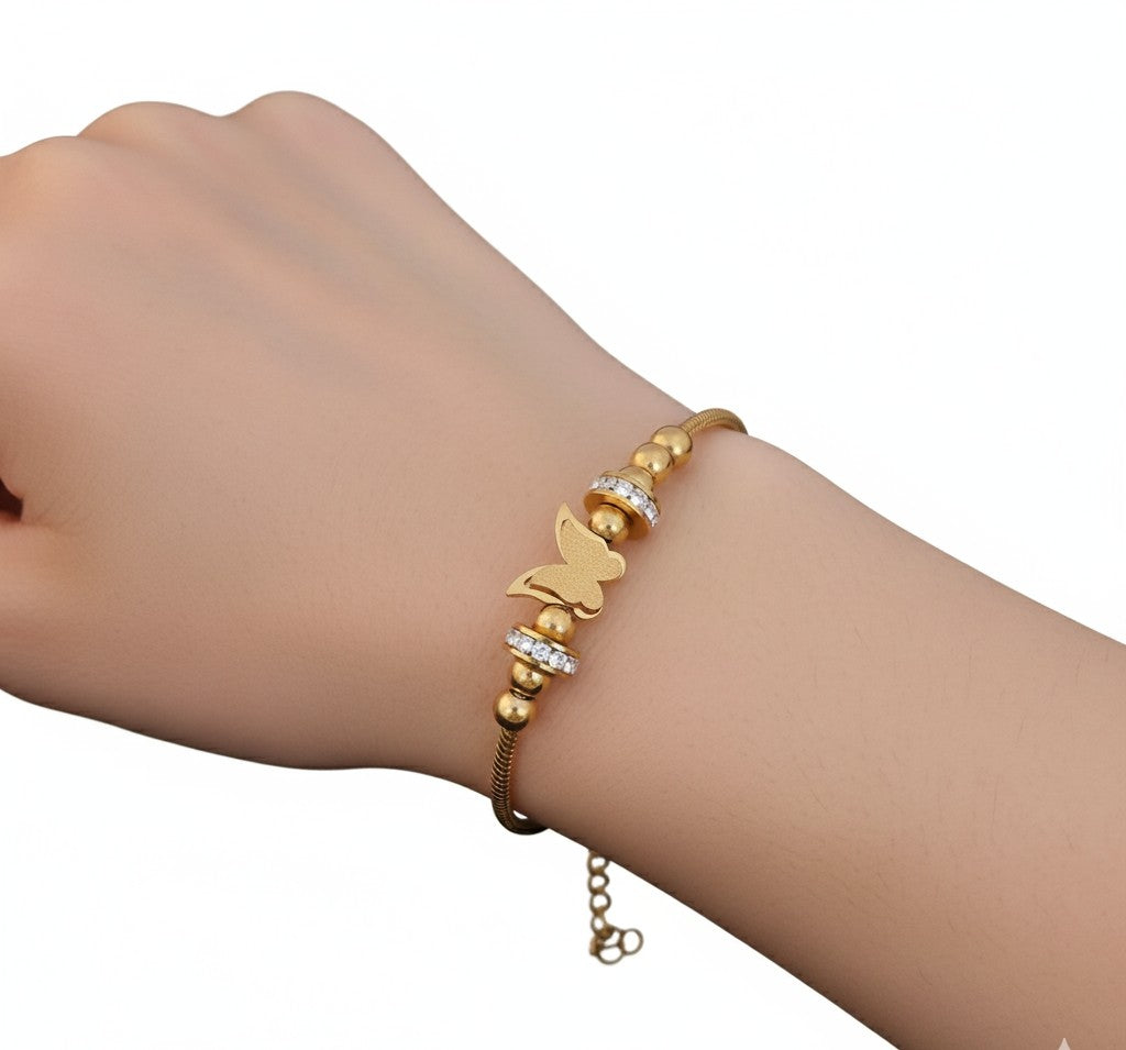 Woman wearing Tavisi Butterfly Charm Anti Tarnish Bracelet crafted in waterproof 22K gold plated 316L surgical stainless steel.