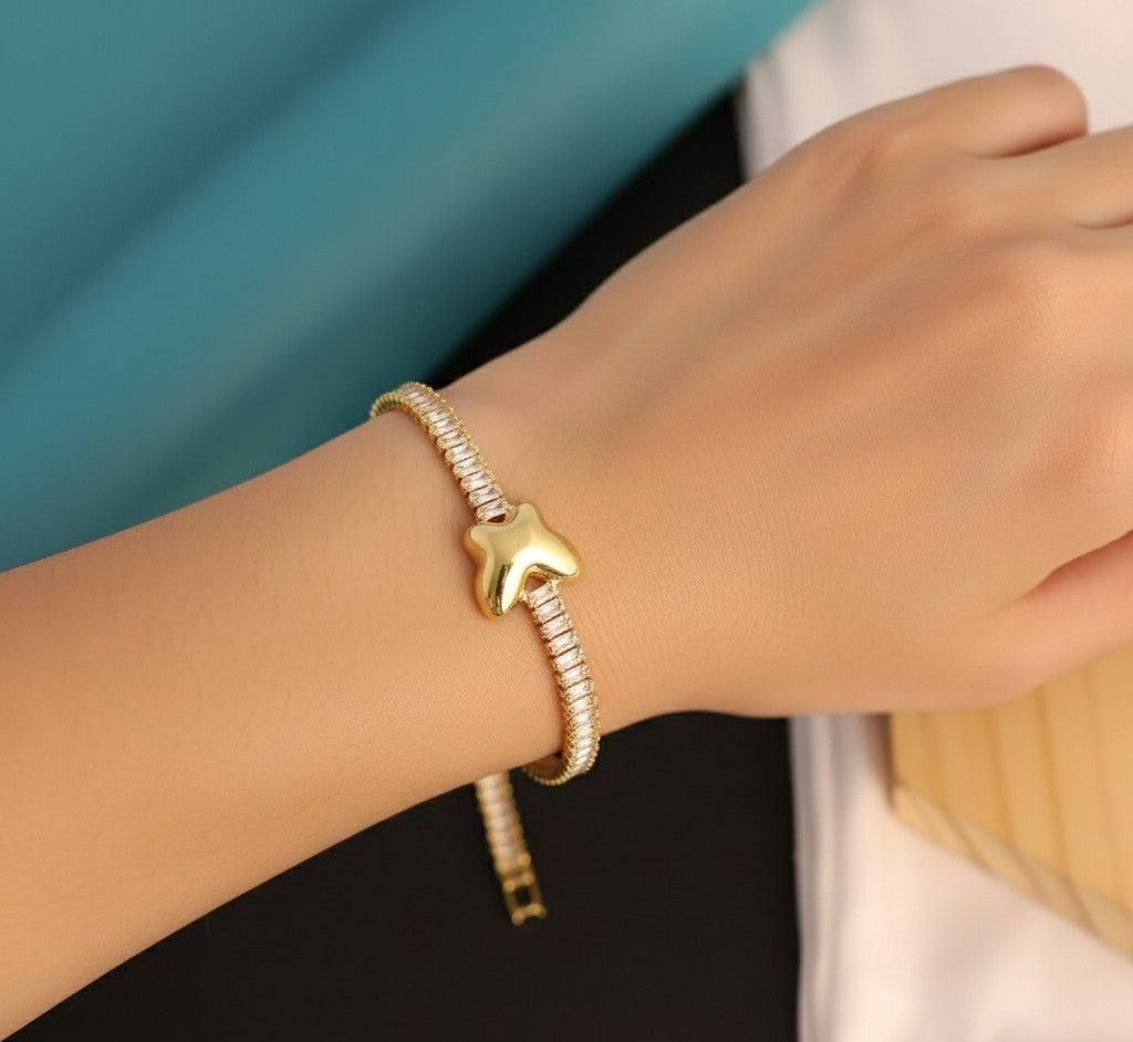 Woman wearing Tavisi Butterfly Tennis Bracelet crafted in 316L surgical stainless steel with 22K gold plating and zircon stones