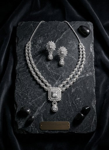 Tavisi Crystal Royale AD CZ premium brass silver finish statement necklace set with matching earrings displayed on a black stone slab for bridal, wedding and party wear.
