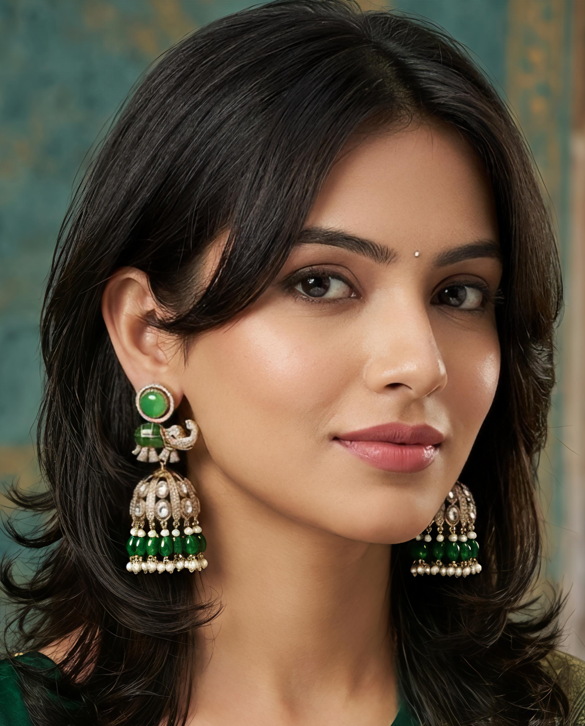 Model wearing Tavisi CZ kundan elephant jhumka earrings in mehendi tone finish with pearl accents