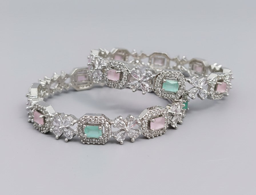 Angle view of Tavisi Dream Petals pastel color CZ silver polish bangle with long lasting finish