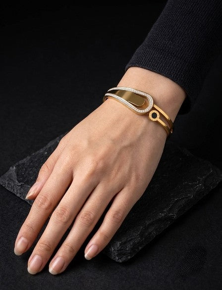 Gold plated AD stone stainless steel bracelet worn on a woman's wrist.