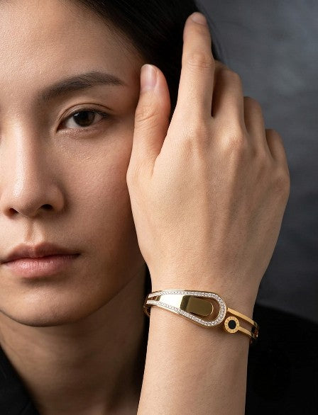 Woman wearing Tavisi Elara Luxe gold plated AD stone stainless steel bracelet.