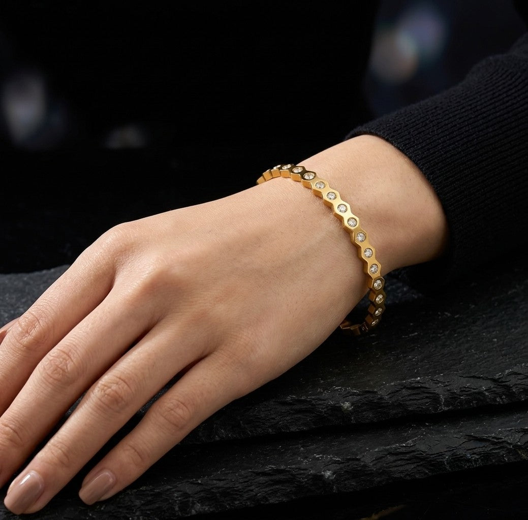 Tavisi Elara Spark gold plated AD stone anti tarnish bracelet close-up on a dark background. 