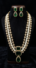 Front view of Tavisi emerald pearl moissanite kundan necklace set with white moissanite stones, emerald stones and pearl strands.
