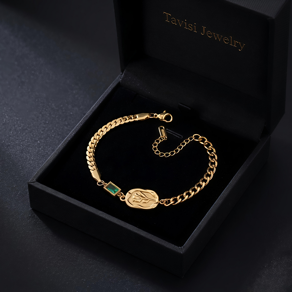 Tavisi Emerald Rose Chain Bracelet crafted in 316L surgical stainless steel with 22K gold plating, featuring a rose engraved centerpiece, green accent detail, waterproof anti tarnish finish and long lasting shine.