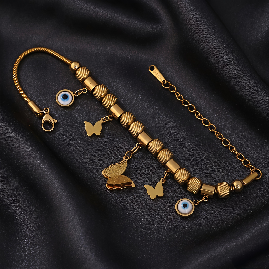 Close-up view of Tavisi Evil Eye Butterfly Charm Bracelet featuring butterfly charms, evil eye details, 22K gold plated 316L surgical stainless steel, waterproof anti tarnish finish and long lasting shine.