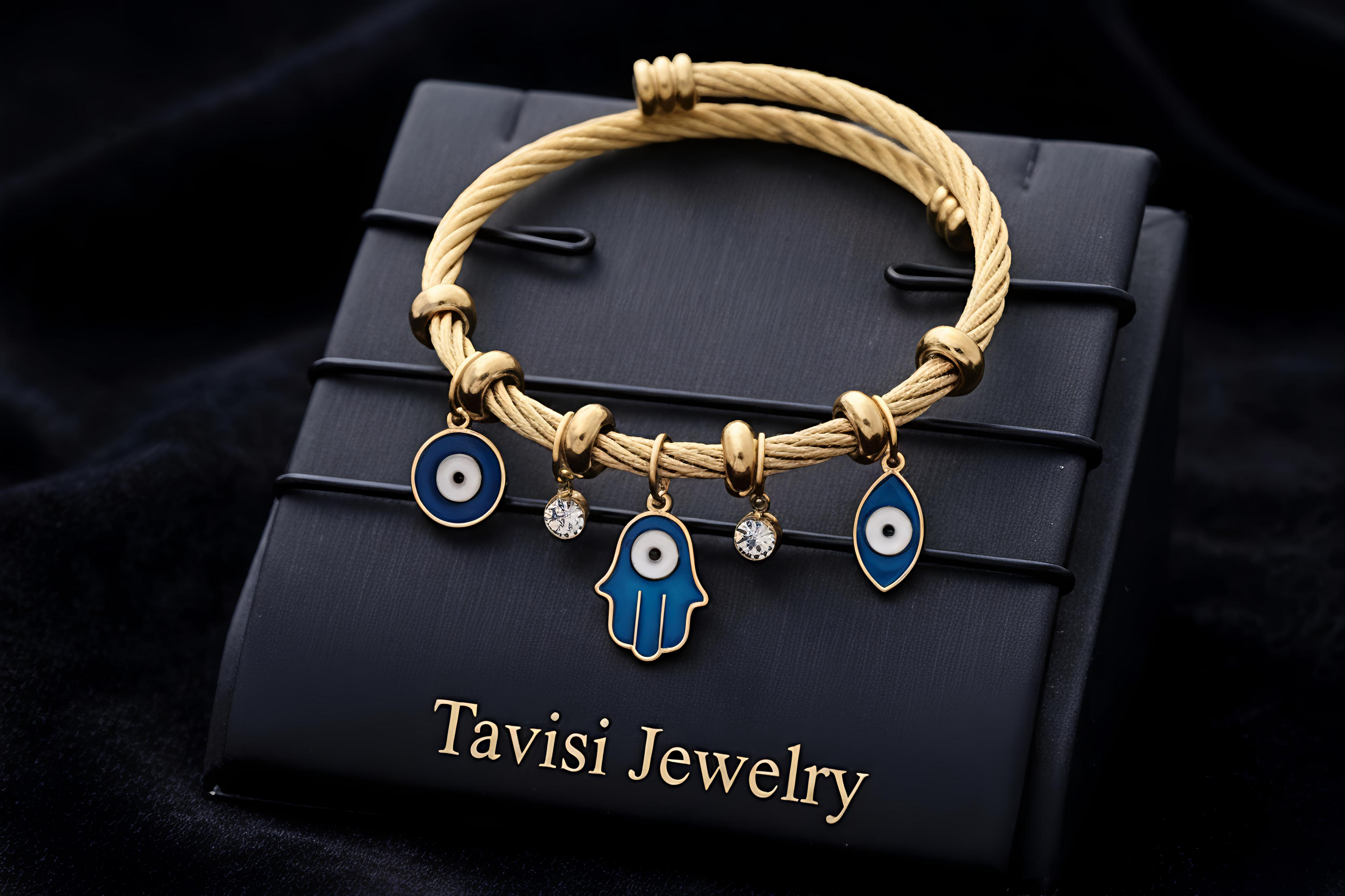 Tavisi Evil Eye Gold Charm Bracelet in 316L surgical stainless steel with 22K gold plated anti tarnish finish, evil eye and hamsa charm detailing, lightweight waterproof adjustable design
