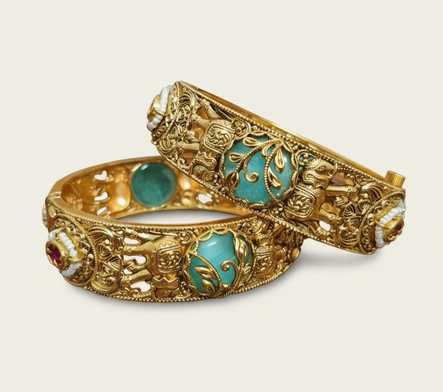 Angle view of Tavisi handcrafted elephant motif gold plated bangles with turquoise stones