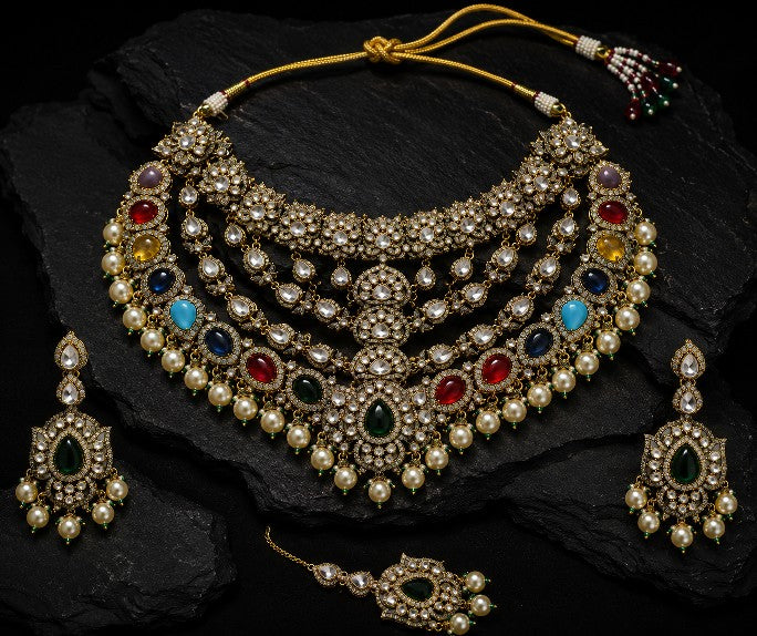Close-up of Tavisi handcrafted brass casting AD kundan bridal necklace with multicolor stones and pearl detailing.