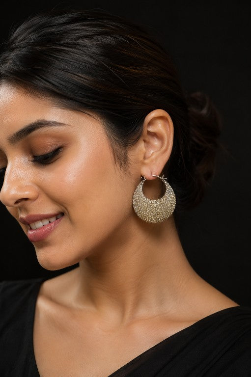 Model wearing Tavisi crescent moon pavé hoop earrings in silver tone with sparkling AD and CZ stones