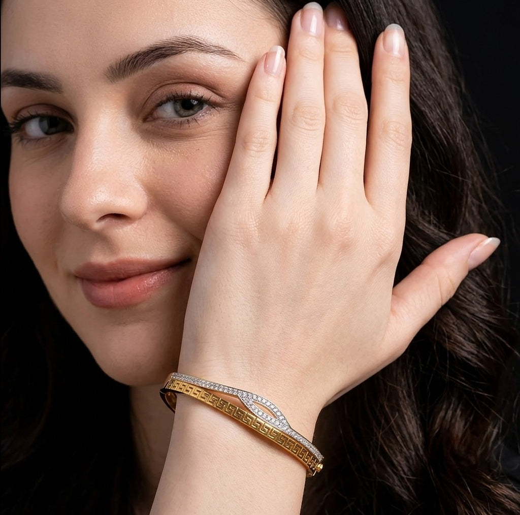 Woman wearing Tavisi Aurelia Wave gold plated AD stone anti tarnish bracelet.