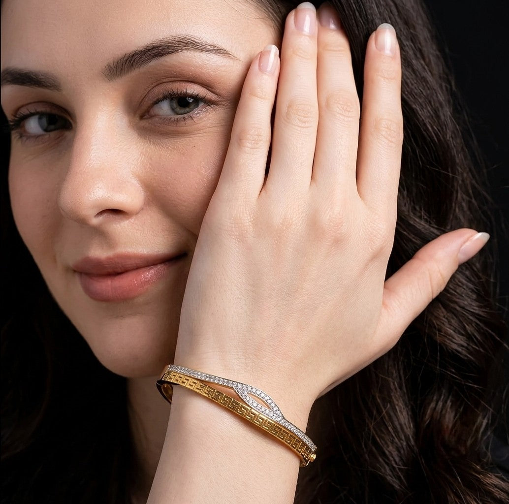 Woman wearing Tavisi Aurelia Wave gold plated AD stone anti tarnish bracelet.