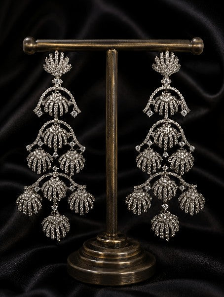 Royal Tavisi shell chandelier earrings displayed in premium luxury presentation with silver tone AD and CZ stones