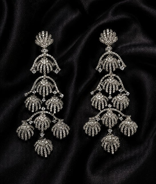 Front view of Tavisi royal shell chandelier earrings with sparkling AD and CZ stones in silver tone finish