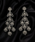 Front view of Tavisi royal shell chandelier earrings with sparkling AD and CZ stones in silver tone finish