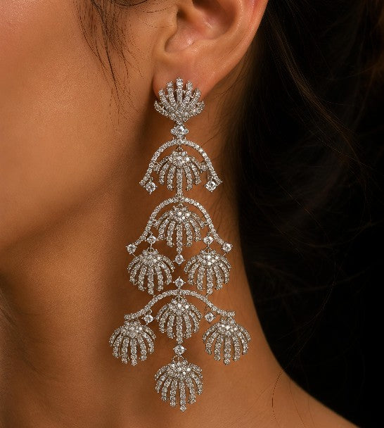 Model wearing Tavisi royal shell chandelier earrings in silver tone with sparkling AD and CZ stones