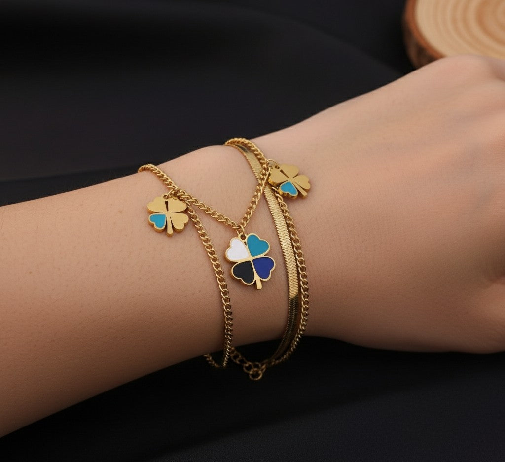 Detailed view of Tavisi Lucky Clover Charm Bracelet with colorful clover charms, premium 316L surgical stainless steel, 22K gold plating and waterproof anti tarnish coating.
