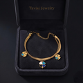 Tavisi Lucky Clover Charm Bracelet crafted in 316L surgical stainless steel with 22K gold plating, featuring colorful clover charms, dual chain design, waterproof anti tarnish finish and long lasting shine.