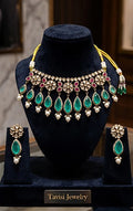 Tavisi long lasting brass casting mehendi finish CZ AD kundan pearl necklace set with green  Zambian emerald stones front view.