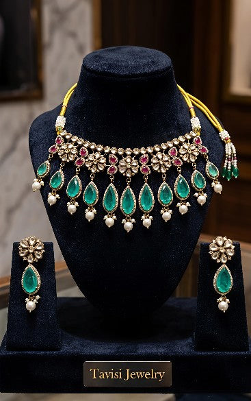 Tavisi long lasting brass casting mehendi finish CZ AD kundan pearl necklace set with green  Zambian emerald stones front view.