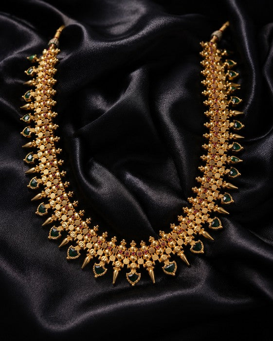 Tavisi palakka necklace featuring green and ruby stones with intricate traditional detailing