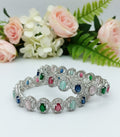 Angle view of Tavisi Rainbow Luxe multicolor CZ silver polish bangle with long lasting finish