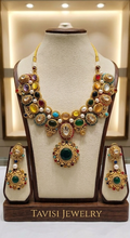 Tavisi Regal Mosaic moissanite necklace set with Kundan, synthetic emeralds, rubies, semi-precious beads and premium gold finish.