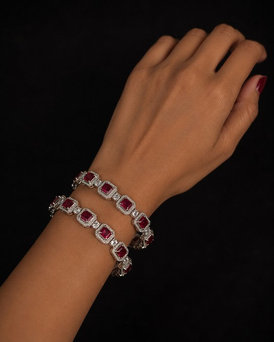 Model wearing Tavisi Regal Spark CZ Silver Polish Bangles featuring white CZ stones with ruby red center stones and a premium silver polish finish. Available in sizes 2.6 and 2.8.