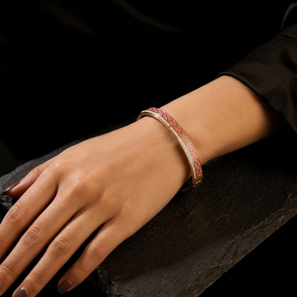Tavisi Roselle Glow 22K gold plated anti tarnish bracelet with pink enamel and AD stones on a dark background.