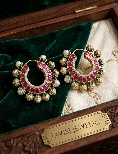 Tavisi royal Kundan hoop earrings with pearls, AD, CZ, and meenakari detailing displayed in premium luxury presentation