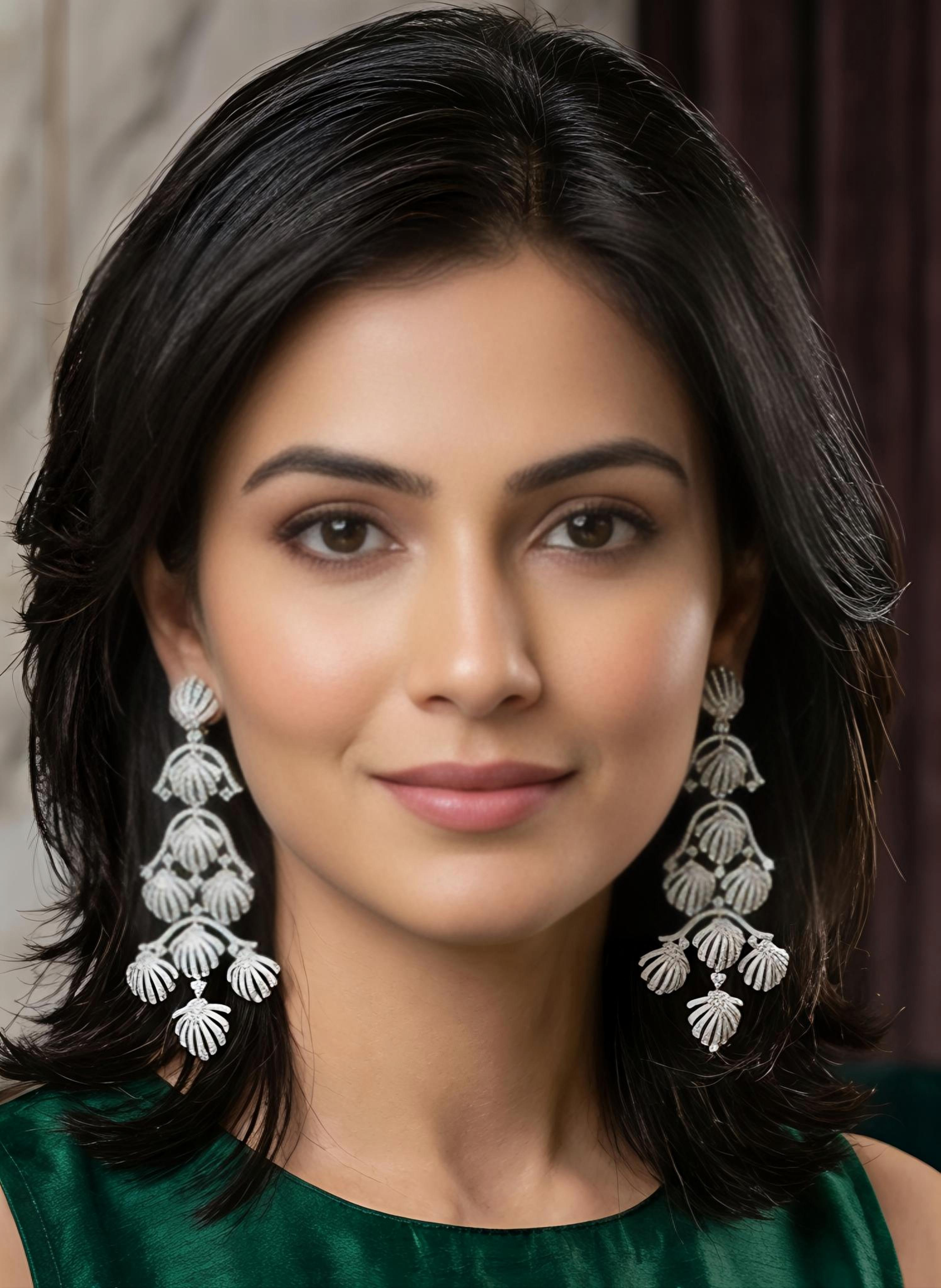 Model wearing Tavisi royal shell chandelier earrings in silver tone with sparkling AD and CZ stones