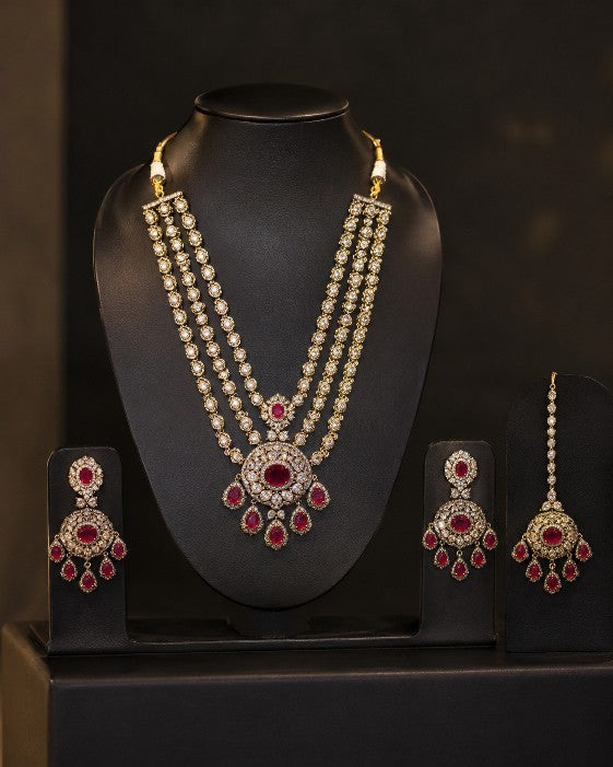 Tavisi Ruby Majesty layered necklace set with AD stones, white CZ stones, ruby pink stones and mehanti color finish.
