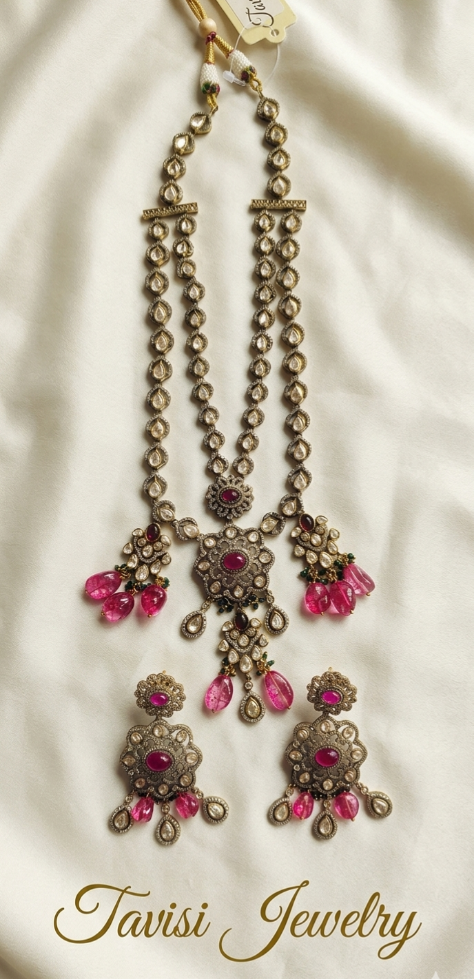 Close-up of Tavisi Ruby Noir layered necklace with white CZ stones, AD detailing, ruby pink beads and premium brass casting.
