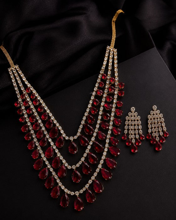 Tavisi Ruby Rajkumari AD Stone Heavy Bridal Choker Earrings and Chutti Set Premium Brass Casting Ruby Red Luxury Jewellery