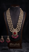 Tavisi Ruby Royale layered necklace set with AD stones, white CZ stones, ruby red stones, ruby beads, brass casting and mehanti color finish.
