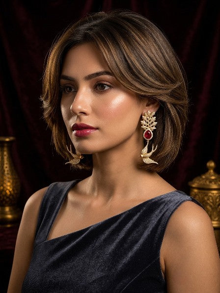 Model wearing Tavisi Sabyasachi Inspired Red Bird Motif AD CZ Gold Plated Brass Bridal Statement Earrings