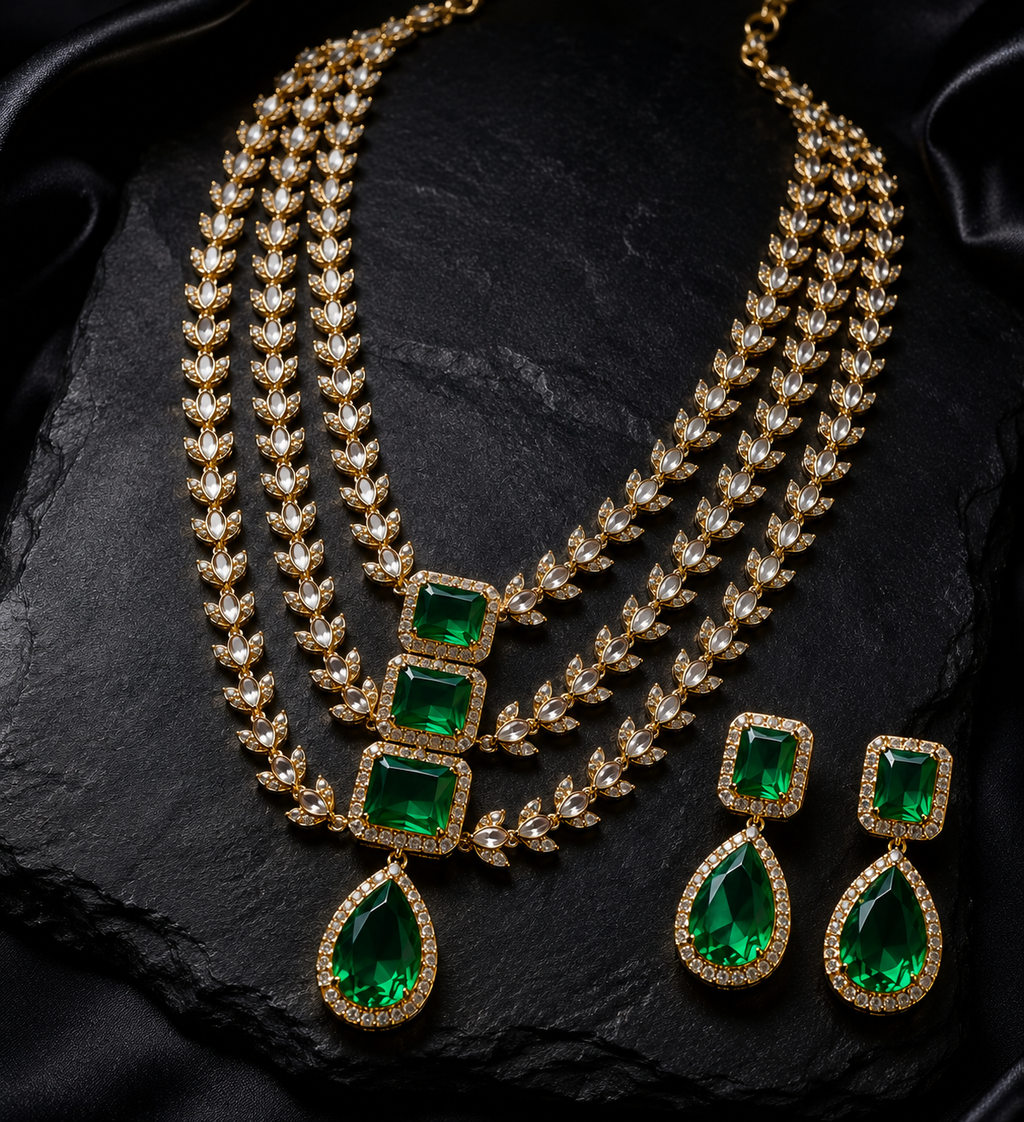 Close-up detail of Tavisi Victorian polki kundan necklace set with white stones, emerald green stones and three layer design.