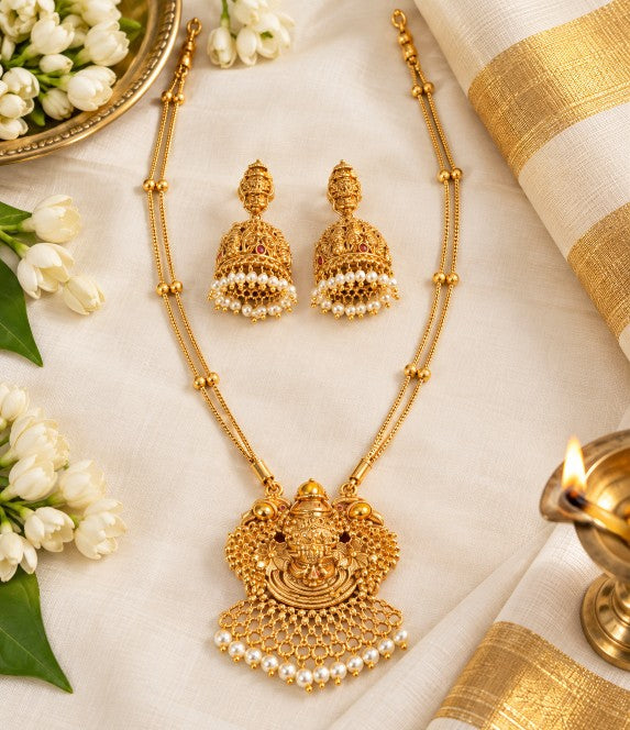 Antique Gold brass pendant necklace with detailed heavy-work jhumka earrings and pearl embellishments