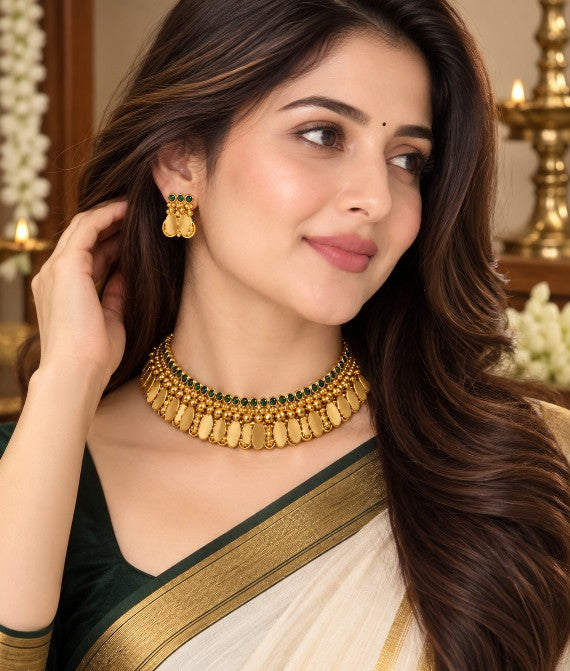 Woman wearing Emerald Stone Coin Elakkathali choker necklace and matching earrings