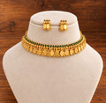 Vaishnavi Emerald Stone Coin Elakkathali Choker Set in antique gold finish