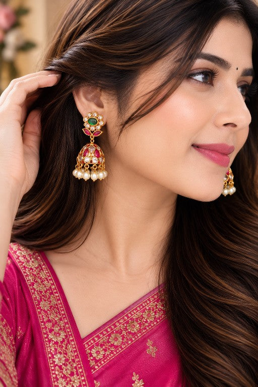 Woman wearing Vallari premium brass floral and leaf jhumka earrings with pearl drops
