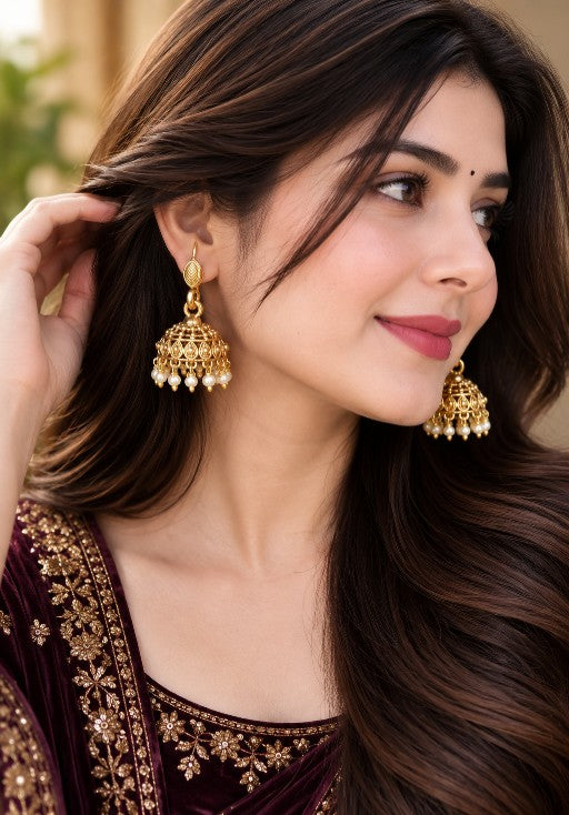 Woman wearing Varnika premium brass pearl jhumka earrings with elegant pearl drops