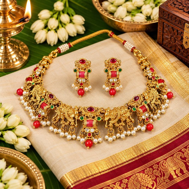 Vasudha elephant motif necklace with red green stones and pearl-style drops