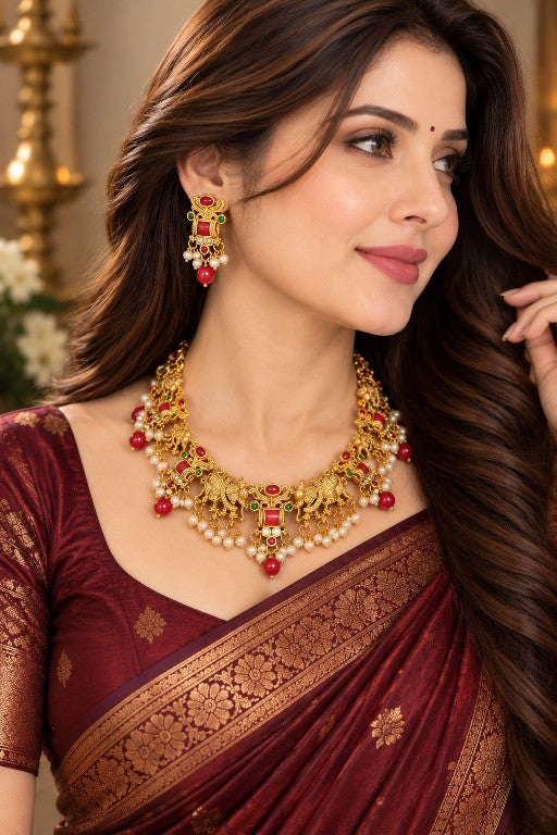 Traditional elephant motif necklace set with red green stones and matching earrings